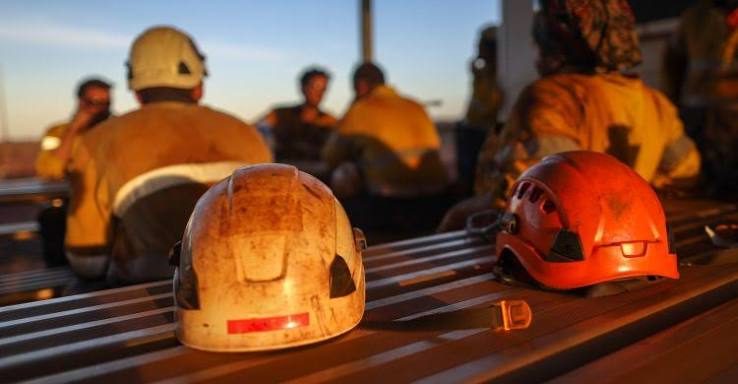 Crew at the end of a shift, hard hats down